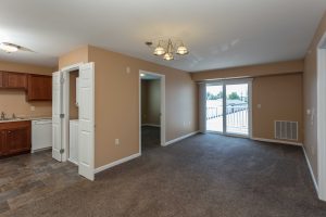 Living room and kitchen with hanging lights at Meyer Pointe.