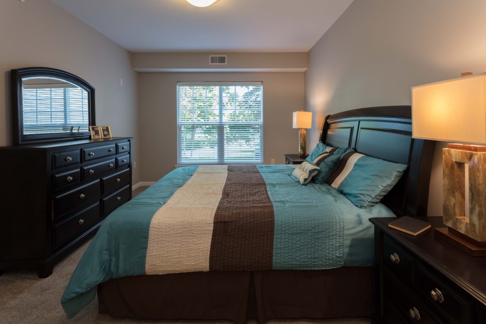Furnished main bedroom at Muir Lake Luxury Apartments in Amherst.