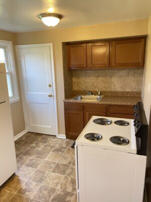 Kitchen will stove, sink, cabinet space.