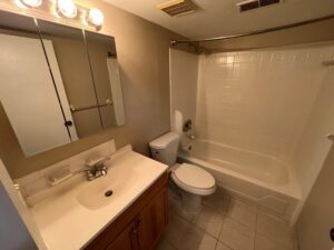 The West Summerset Apartments full size bathroom with cabinets under the sink.