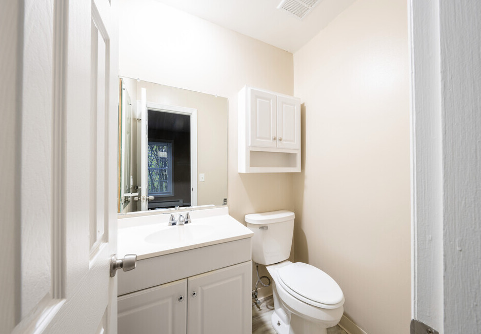 Bright bathroom with white cabinets.