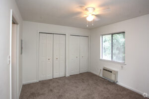 Bedroom with ceiling fan and bright light in Guilford Place Apartments.
